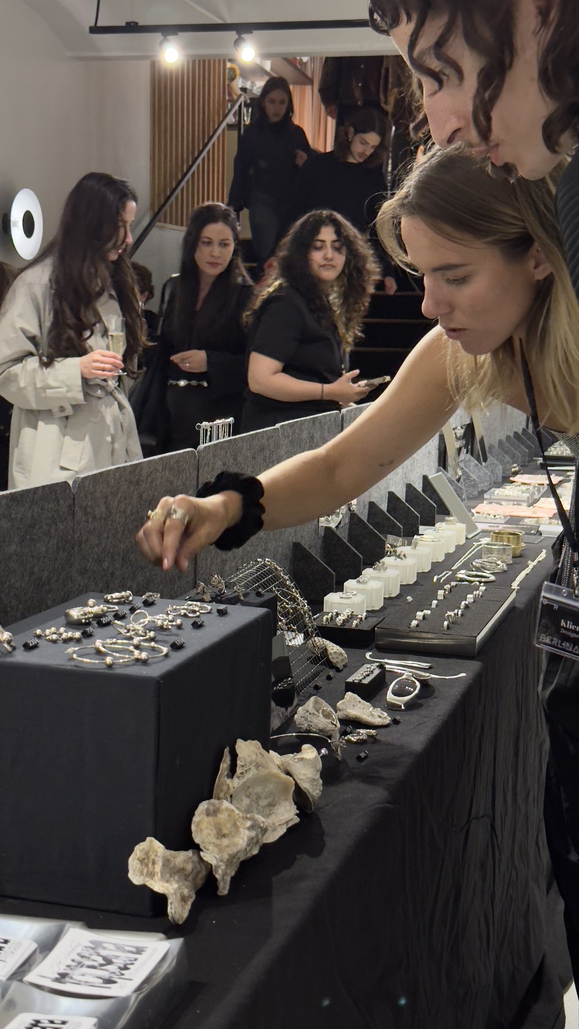 Rings displayed with flowers on the Berlinate8 table.