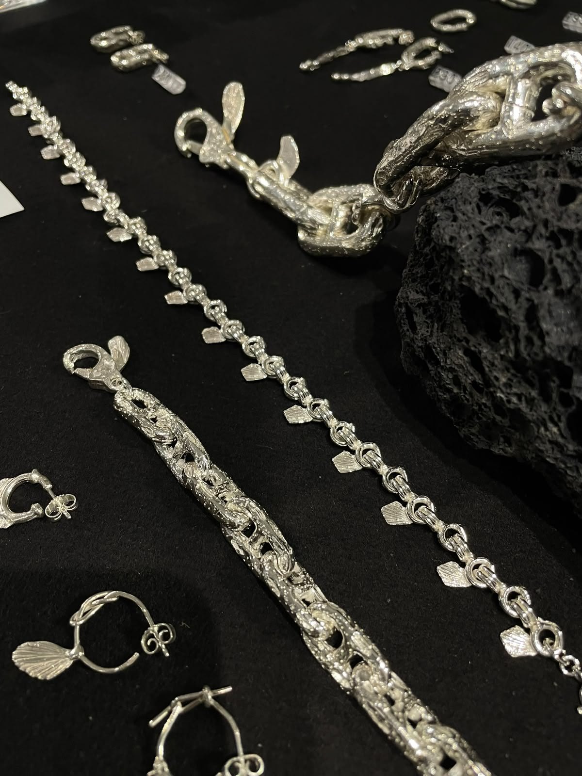 Sculptural silver and glass pieces on the table.